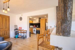 a kitchen and living room with a large tree at Villa Solsticia in Albitreccia