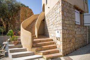 a set of stairs next to a brick wall at Villa Solsticia in Albitreccia