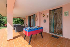a room with a foosball table in the middle of a room at Tenuta Vallegaia in Rosignano Marittimo