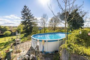 a hot tub in the garden of a house at Bourdeverre Chambres D'hôtes in Sanxay