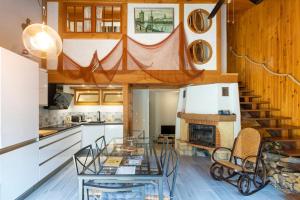 a kitchen with a glass table and a staircase at Villa Patio Proche Plage in Seignosse +14 photos