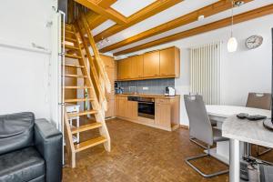 a kitchen with a table and a ladder in a room at Moin Moin in Friedrichskoog-Spitze