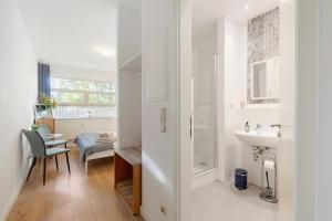a white bathroom with a sink and a shower at Albrechtshof in Potsdam +141 photos