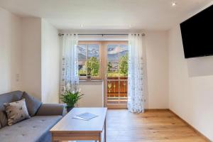 a living room with a couch and a large window at Ferienwohnung Johanni in Farchant