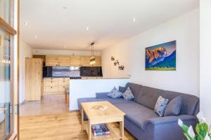 a living room and kitchen with a couch and a table at Ferienwohnung Johanni in Farchant