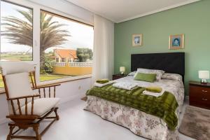 a bedroom with a bed and a large window at Villa Laurana in Suances