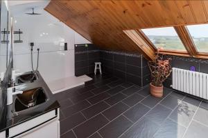 a kitchen with a sink and a wooden ceiling at Villa Laurana in Suances +37 photos