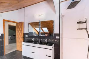 a kitchen with white cabinets and a sink at Villa Laurana in Suances