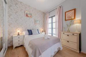 a bedroom with a bed and two night stands and a window at Iconic Center in Seville