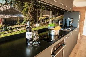 a bottle of wine sitting on top of a kitchen counter at Kieserhof Apartment Alm in Terento