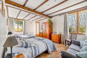 a bedroom with a large bed and a couch at Bourdeverre Chambres D'hôtes in Sanxay +53 photos
