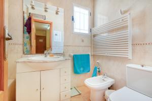 a bathroom with a sink and a toilet and a mirror at Oliva Avinyo in Oliva +16 photos
