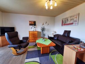 a living room with a couch and a table at Zur schönen Aussicht in Schotten