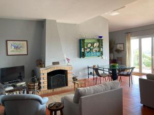 a living room with a couch and a fireplace at Country House With Private Pool in Tavira
