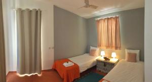 a bedroom with two beds and a window at Country House With Private Pool in Tavira +13 photos