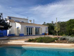 a house with a swimming pool in front of it at Country House With Private Pool in Tavira