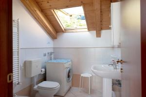 a bathroom with a toilet and a sink and a window at Trilocale in villa Apt 5 in Varazze