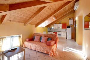 a living room with a couch and a kitchen at Trilocale in villa Apt 5 in Varazze