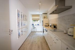 a kitchen with white cabinets and blue plates on the wall at Royal Delft Boutique Apartment in Dinslaken