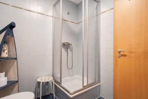 a shower with a glass door in a bathroom at Landhaus Peenemünde - Garten in Peenemünde +15 photos