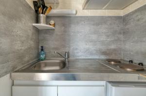 a kitchen with a sink and a counter top at Chez Anne Marie Et Daniel in Gardouch +12 photos