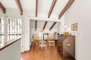 a kitchen and living room with a table and chairs at Casa Limón in Vélez-Málaga +13 photos