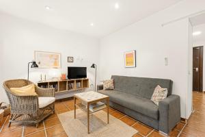 a living room with a couch and a table and chairs at Casa Limón in Vélez-Málaga