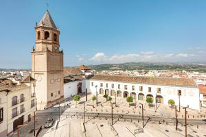 a large building with a clock tower in a city at Casa Limón in Vélez-Málaga