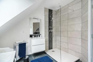 a white bathroom with a shower and a sink at Chambres D'hôtes Les Goélands in Saint-Cast-le-Guildo +25 photos