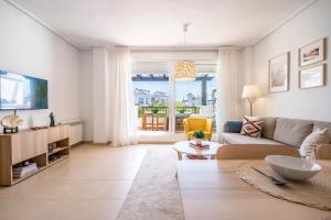 a living room with a couch and a table at Casa Albatros - Poolside Retreat in Torre-Pacheco