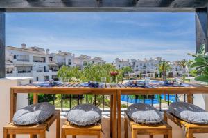 a table with chairs and a view of the city at Casa Albatros - Poolside Retreat in Torre-Pacheco