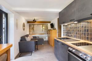 a kitchen with a sink and a couch in a room at Ferienwohnung Christa in Lennestadt