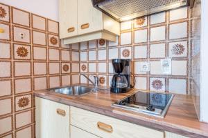 a kitchen with a sink and a counter top at Residence Kronstein - Fewo 7 in Tesimo