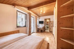 a bedroom with a bed and a desk at Residence Kronstein - Fewo 7 in Tesimo