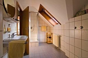 a bathroom with a sink and a bath tub at Kempfenhof in Seelbach +89 photos