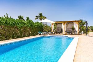 a swimming pool in front of a house at Finca Can Cocou in Can Picafort