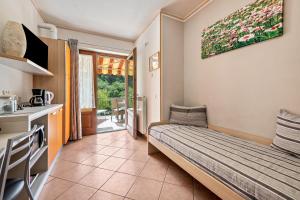 a small room with a bed and a kitchen at Residence Tatiana A1 in Tremosine Sul Garda +29 photos