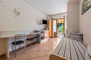 a kitchen and living room with a table and chairs at Residence Tatiana A1 in Tremosine Sul Garda