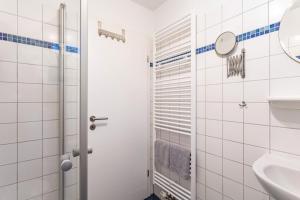 a bathroom with a toilet and a sink at Fewo Zur Piste in Willingen +17 photos