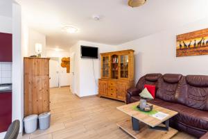 a living room with a couch and a table at Fewo Zur Piste in Willingen