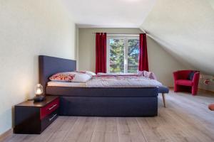a bedroom with a bed and a window at Ferienwohnung Waldidyll in Wolgast +25 photos