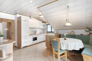 a kitchen with a table and a dining room at Gieringer in Oberharmersbach