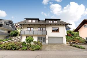 a white house with a garage at Gieringer in Oberharmersbach