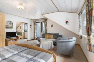 a bedroom with a bed and a living room at Gieringer in Oberharmersbach