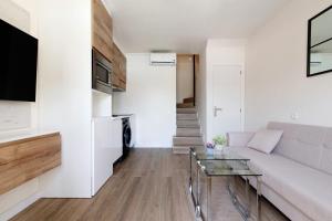 a living room with a couch and a glass table at Oasis Pool View in Maspalomas