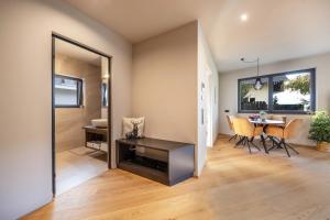 a living room with a table and a dining room at Apartment 16 cityview in Cornedo all'Isarco