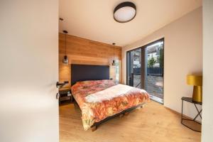 a bedroom with a bed and a large window at Apartment 16 cityview in Cornedo all'Isarco