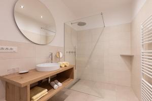 a bathroom with a sink and a mirror at Kleon 2 in Rifiano +26 photos