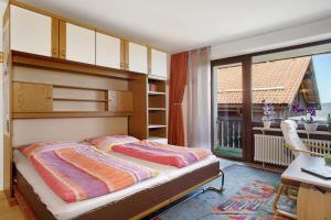 a bedroom with a bunk bed and a balcony at Wanderglück in Missen-Wilhams +19 photos