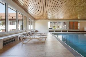 a house with a pool and a chair next to it at Wanderglück in Missen-Wilhams